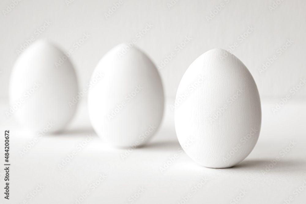 Three white eggs on a white background Three white eggs on a white background