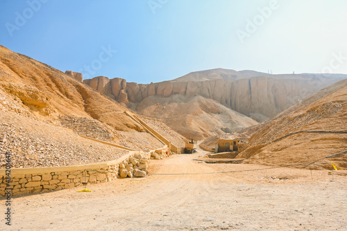Valley of the kings where there are tombs for pharaohs, with sandy rock cliff and mountain in the back in Luxor, Egypt