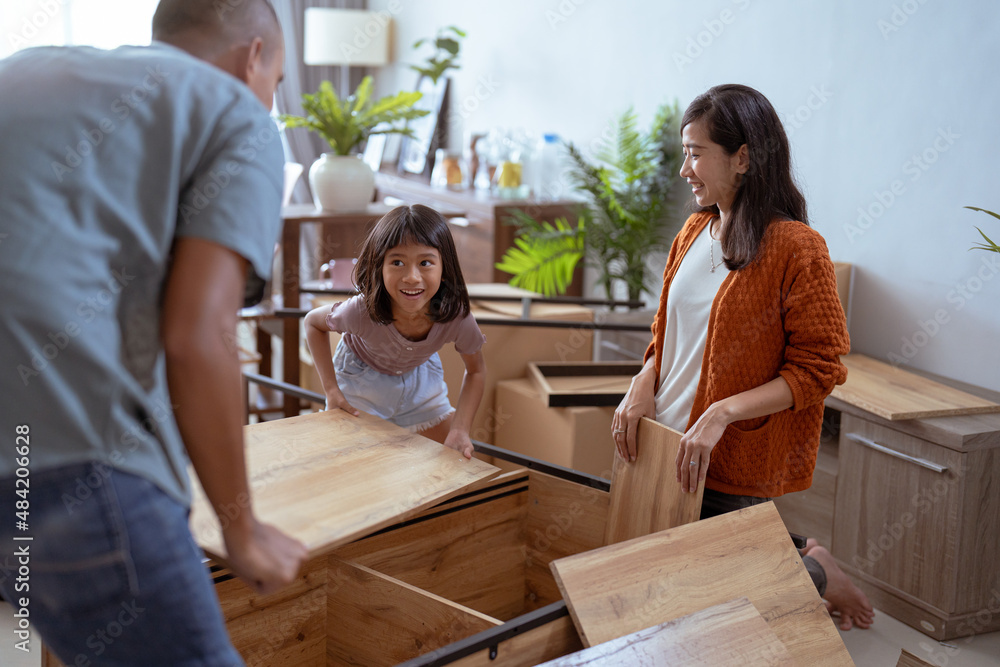 asian family at their new house buying and assembling new furniture. asian family at their new house buying and assembling new furniture.