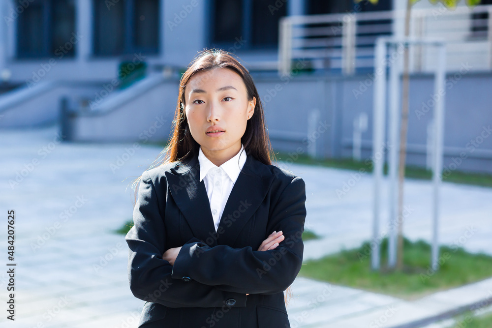 Portrait of a pensive Asian business woman dressed in business clothes Portrait of a pensive Asian business woman dressed in business clothes