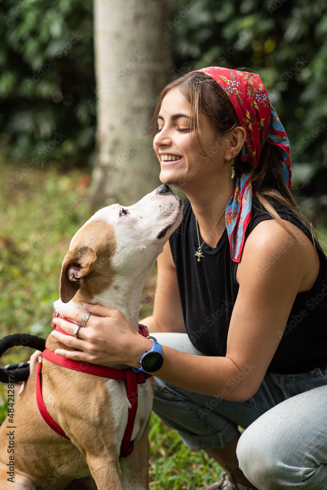 A young woman with a Pitbull mix