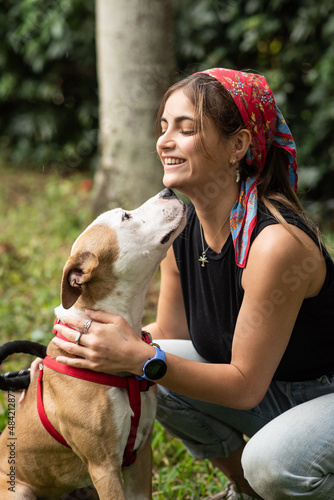 Obraz na płótnie A young woman with a Pitbull mix w salonie