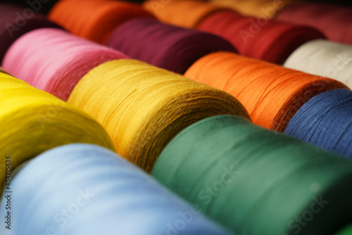 Colorful thread spool background, close-up photo