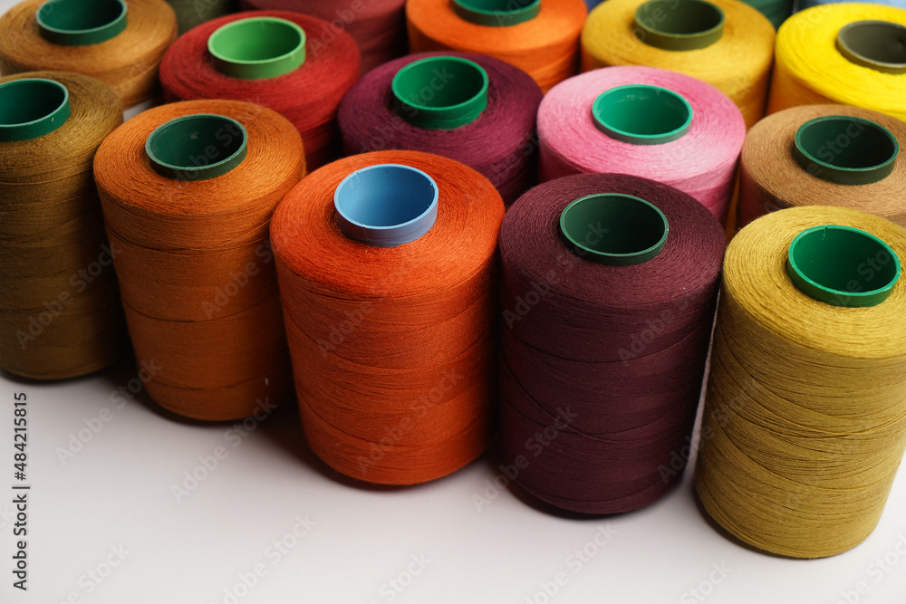 Colorful thread spool background, close-up Colorful thread spool background, close-up