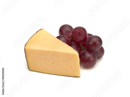 Piece of cheese and grapes isolated on white background