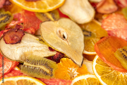 background from various multicolored dried fruits, top view