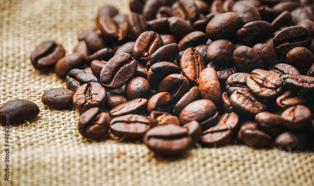 Roasted coffee beans placed on a sack Roasted coffee beans placed on a sack