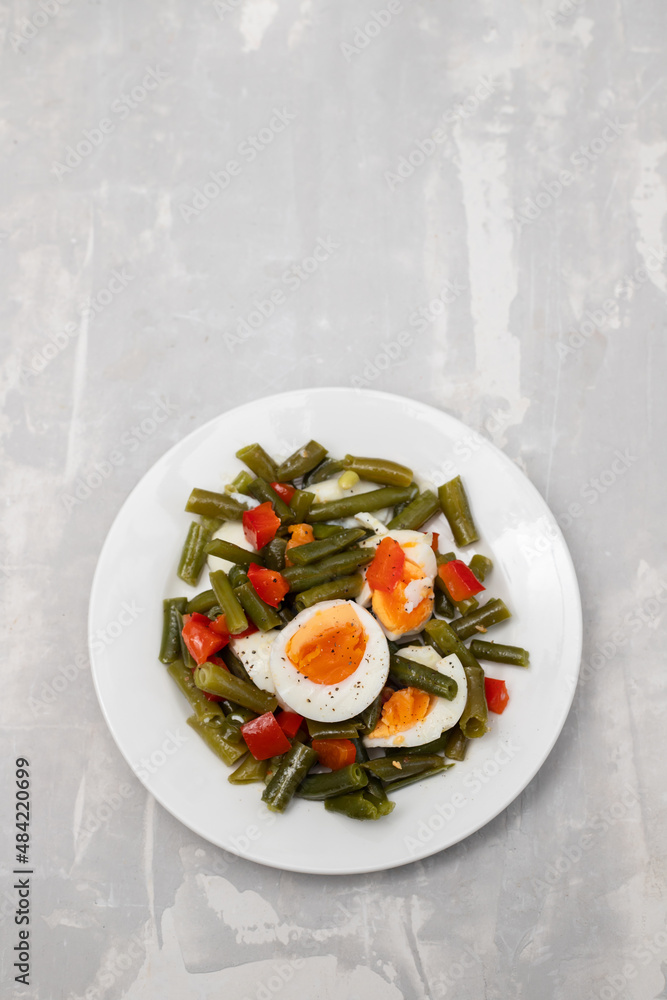 salad green beans, pepper and boiled eggs on plate salad green beans, pepper and boiled eggs on plate