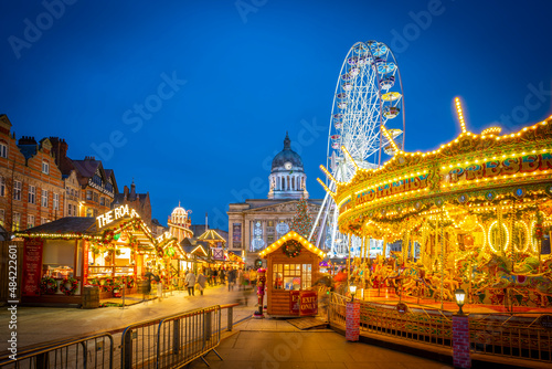 View of Christmas market stalls, ferris wheel and Council House on Old Market Square, Nottingham, Nottinghamshire, England