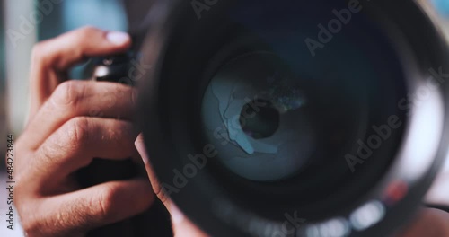 Man aims camera and lens blades close up