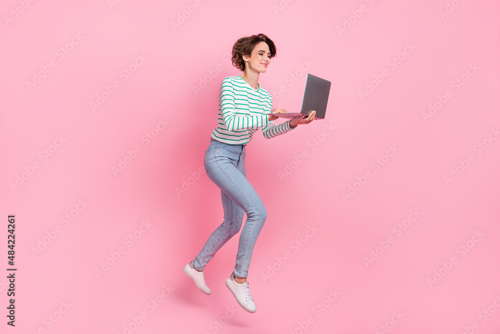 Full body profile photo of cute young bob hairdo lady run with laptop wear shirt jeans sneakers isolated on pink background Full body profile photo of cute young bob hairdo lady run with laptop wear shirt jeans sneakers isolated on pink background