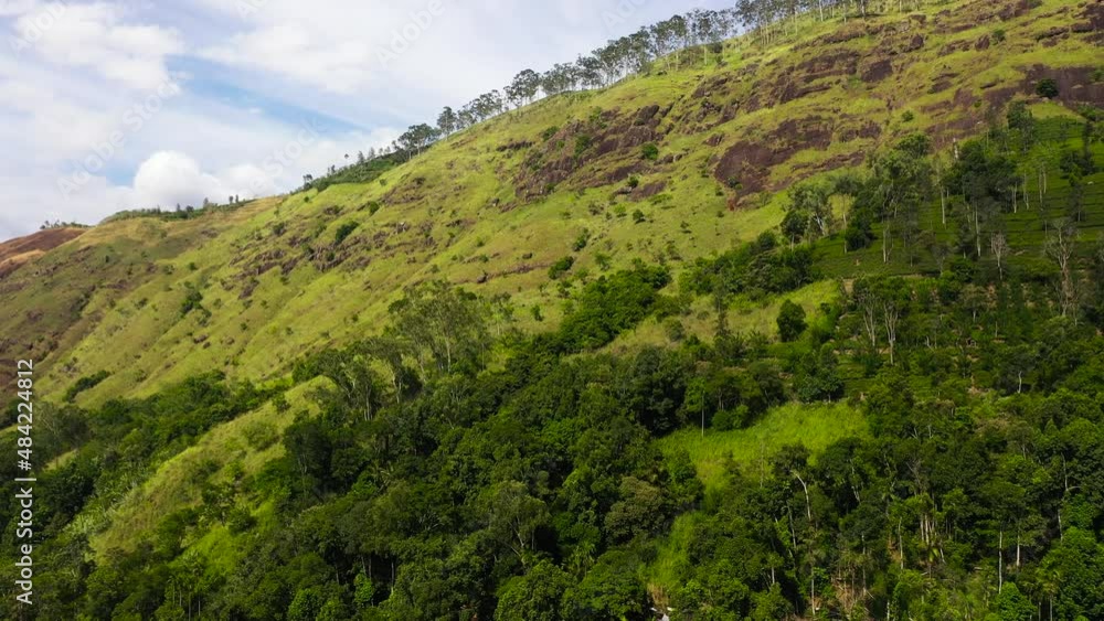 Aerial view of Mountains covered rainforest, trees and blue sky with clouds. Sri Lanka. Aerial view of Mountains covered rainforest, trees and blue sky with clouds. Sri Lanka.