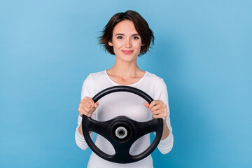 Photo of positive sweet cute lady hold steering wheel learning to ride car isolated on blue color background