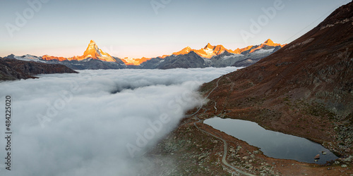 Matterhorn, Dent Blanche, Wellenkuppe and Zinalrothorn peaks in fog from Stellisee lake, Zermatt, Valais canton, Swiss Alps, Switzerland photo