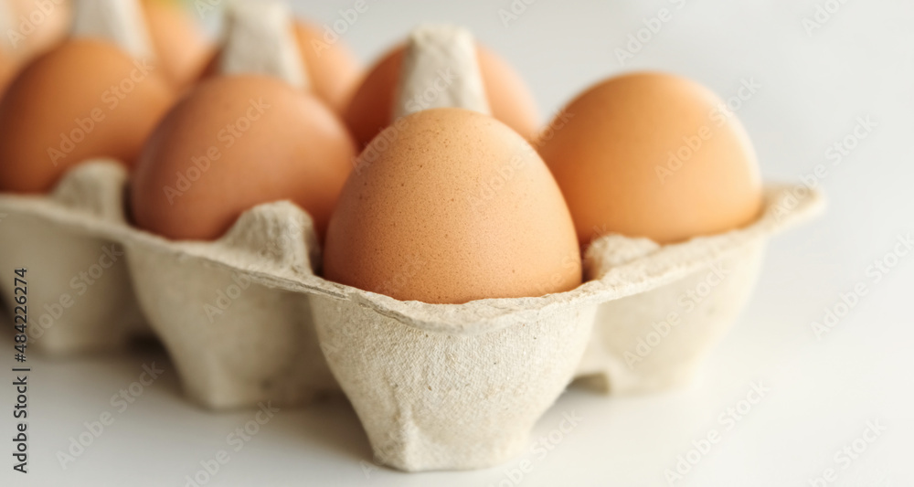 Chiken brown eggs. Organic raw eggs in cardboard boxes container. Chiken brown eggs. Organic raw eggs in cardboard boxes container.