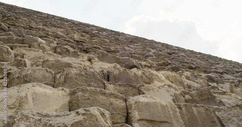 Egyptian pyramid of Giza close up. Panoramic view from the blocks on the blue sky. Clear day, camera looking up Egyptian pyramid of Giza close up. Panoramic view from the blocks on the blue sky. Clear day, camera looking up