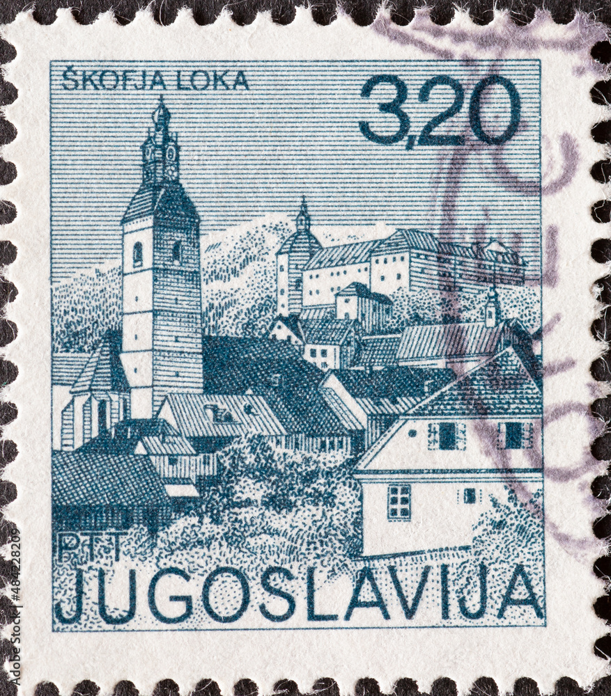Yugoslavia - circa 1975 : a postage stamp from Yugoslavia, showing a townscape of Skofja Loka