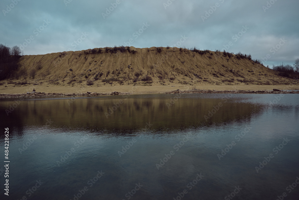 sand quarry with water in late autumn evening
