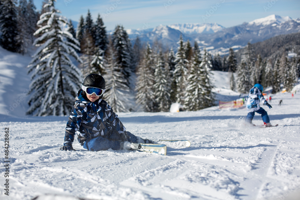 Cute preschool child, skiing in Austrian winter resort on a clear day