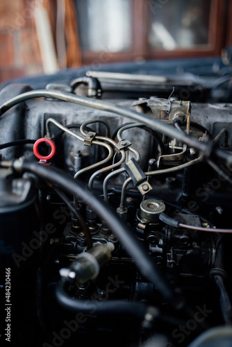Old car engine details in garage.