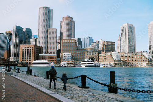 Foto Grandfather and grandson walking the Boston harbor together