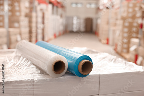Rolls of different stretch wraps on boxes in warehouse