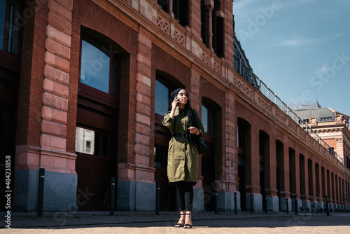 Bussiness muslim woman on a train station photo