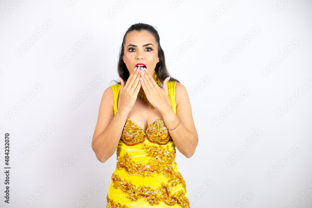 Young beautiful woman wearing carnival costume over isolated white background shocked covering mouth with hands for mistake. secret concept. Young beautiful woman wearing carnival costume over isolated white background shocked covering mouth with hands for mistake. secret concept.