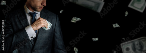 American cash. Business man hand holding dollar sign. Usd bill money falling banner.