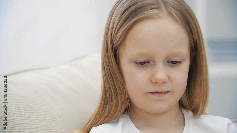 4k slowmotion close up video of surprised little girl reading a book. 4k slowmotion close up video of surprised little girl reading a book.