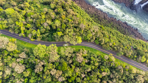 Aerial top view of a highway beside a river in Iguaçu National Park, Parana, Brazil