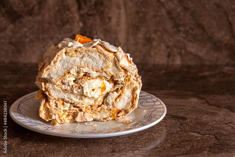 Delicate and airy meringue cake on a plate on the table. Delicate and airy meringue cake on a plate on the table.