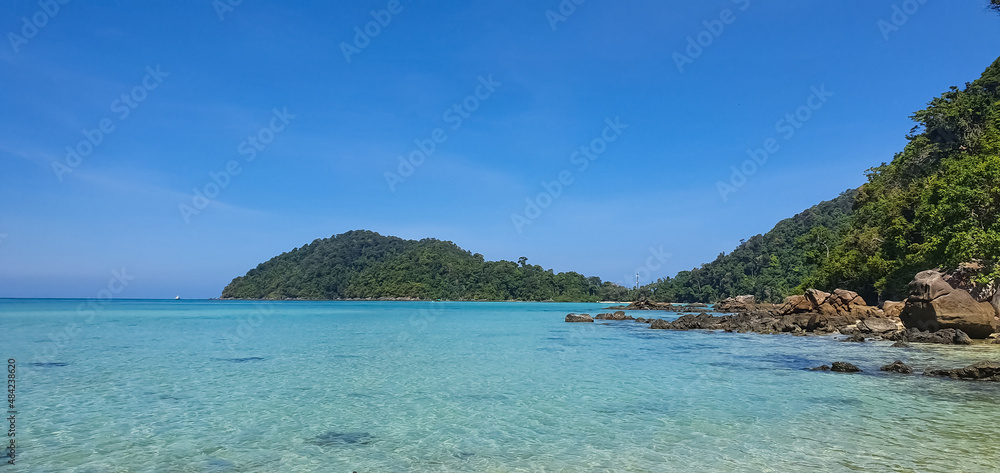 Emerald sea water and beautiful natural rocky seashore. Summer vacation and coastal nature concept.Beautiful small bay with crystal clear turquoise sea water