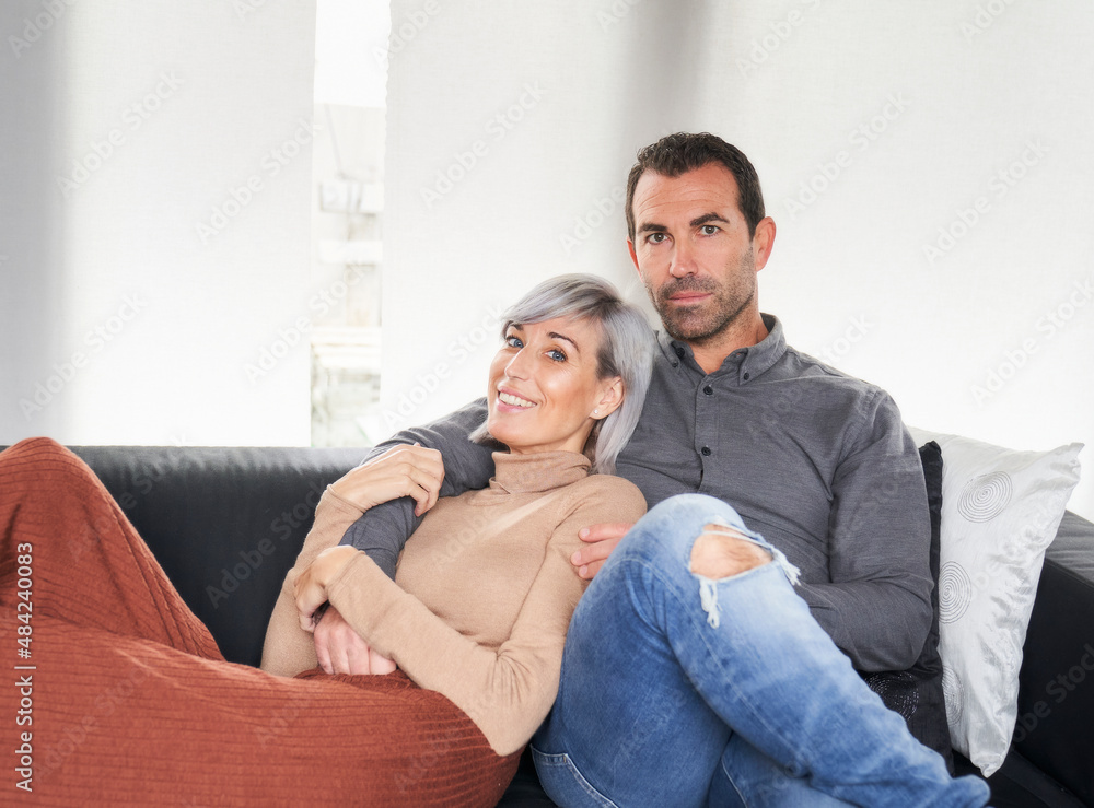 couple formed by a man and a woman seated on an armchair couple formed by a man and a woman seated on an armchair