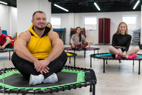 Women's and men's group on a sports trampoline, fitness training, healthy life - a concept trampoline group batut workout men, from lifestyle athletic for sporty from sport shaping, smiling sportswear