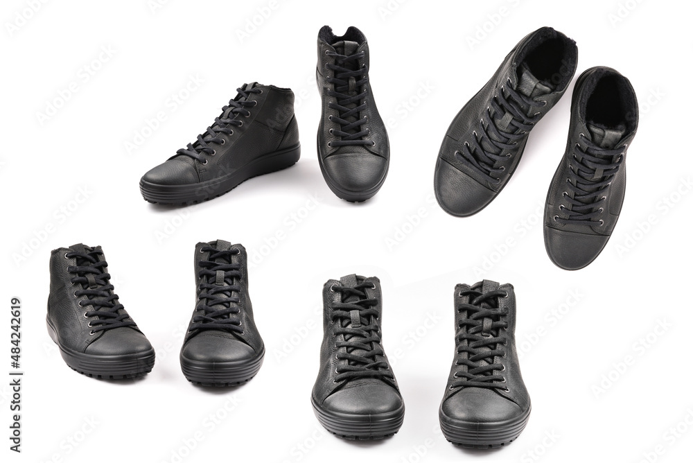men's black leather shoes and a black camera on a black background. Copy space.