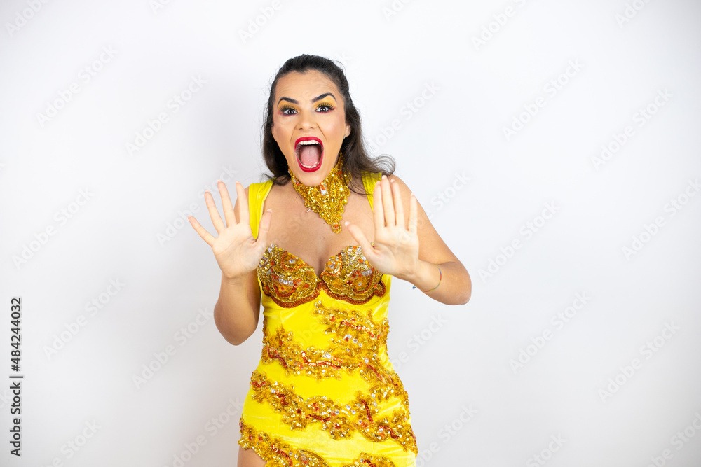 Young beautiful woman wearing carnival costume over isolated white background afraid and terrified with fear expression stop gesture with hands, shouting in shock. Panic concept. Young beautiful woman wearing carnival costume over isolated white background afraid and terrified with fear expression stop gesture with hands, shouting in shock. Panic concept.