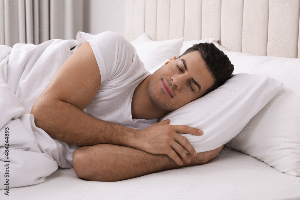 Handsome man sleeping in bed at home Handsome man sleeping in bed at home