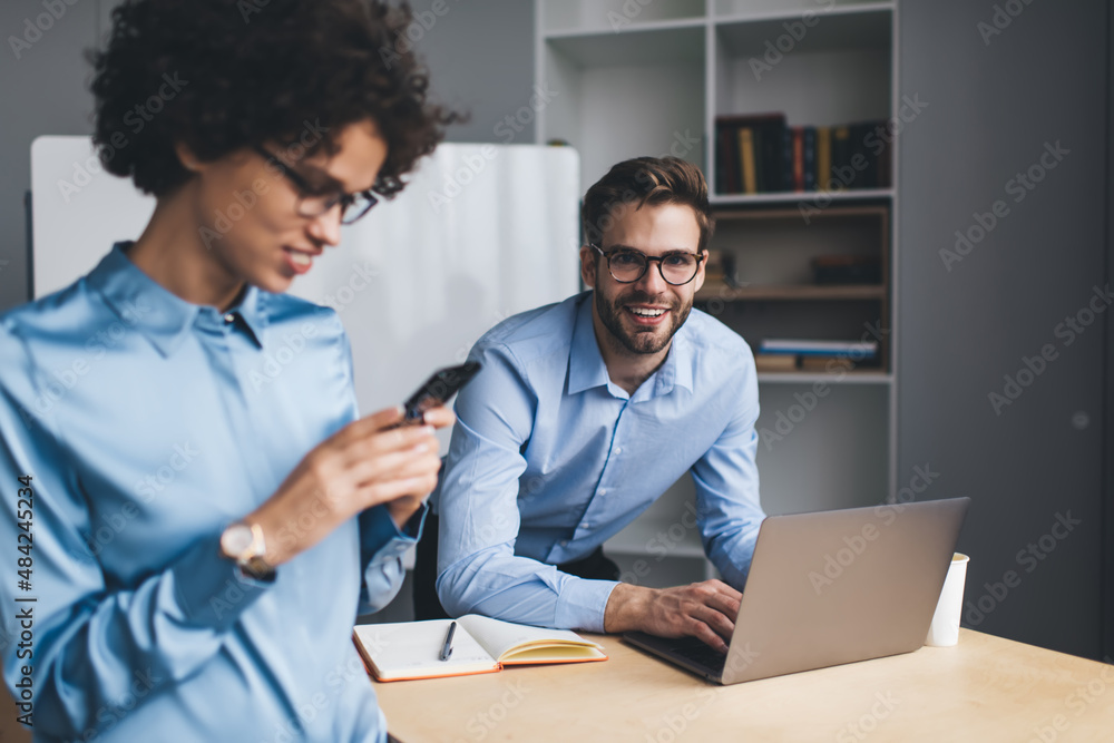 Millenial business man and woman working in office Millenial business man and woman working in office