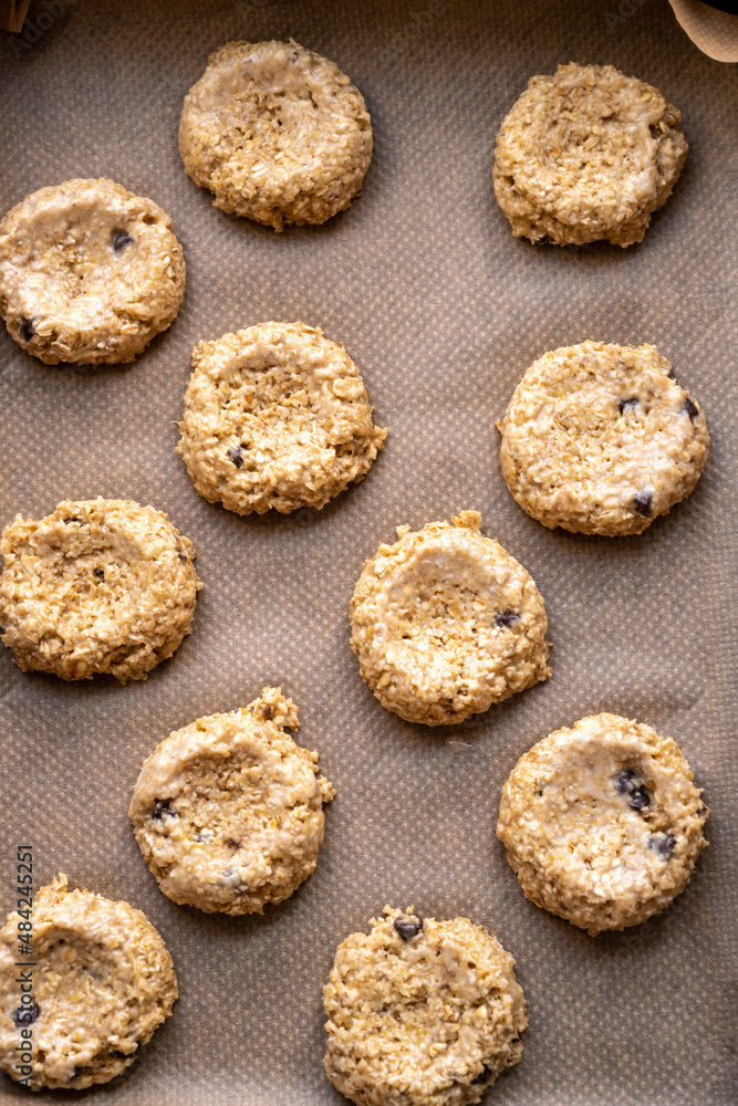 Gluten free raw, uncooked banana cookies with chocolate chips. Healthy homemade biscuits, top view.