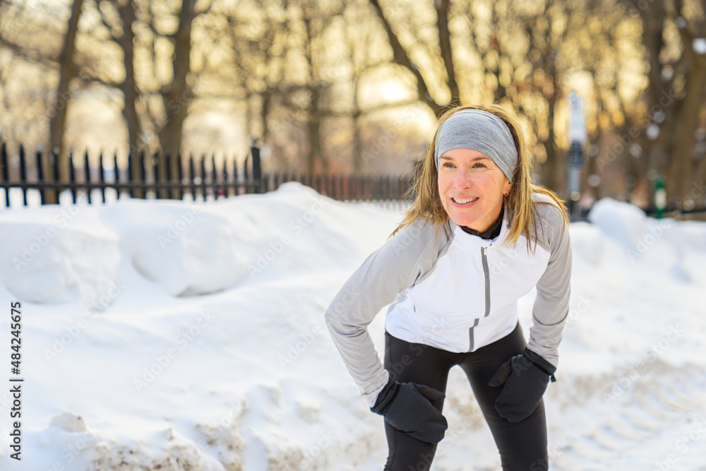 Woman Running in Snowy Park in winter season Woman Running in Snowy Park in winter season