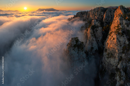 Cloud tide in mountains at sunset © Alexey
