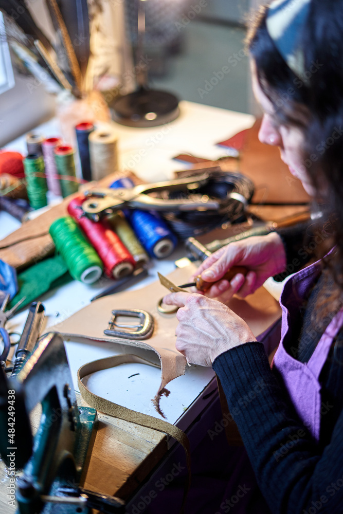 Detail shot Unrecognizable craftswoman working leather Detail shot Unrecognizable craftswoman working leather