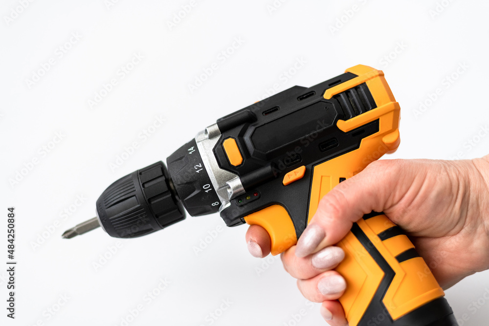 Screwdriver in a female hand on a white background
