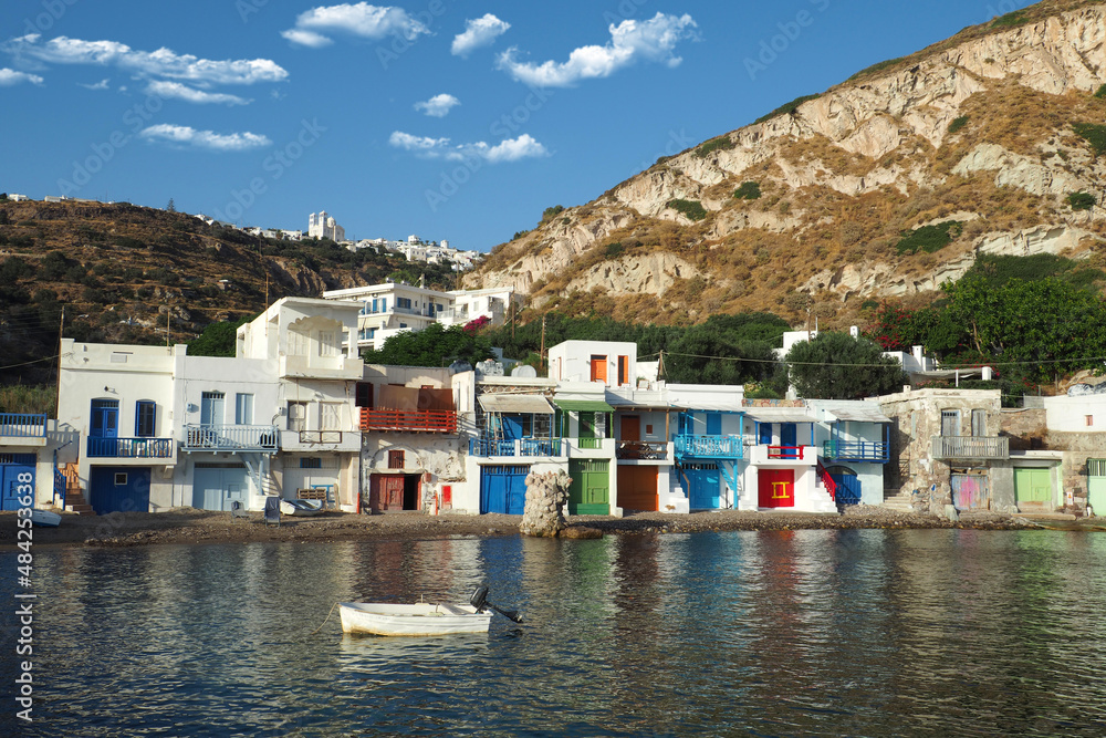 Beautiful fishermen small scenic seaside picturesque village of Klima in entrance of port of Adamantas with colourful boat houses called 