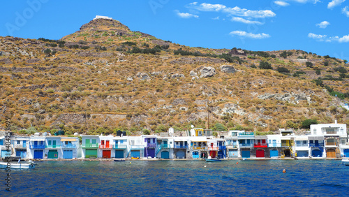 Beautiful fishermen small scenic seaside picturesque village of Klima in entrance of port of Adamantas with colourful boat houses called 