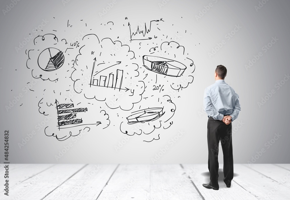 Young businessman wearing a suit and concrete wall with a business plan sketch Young businessman wearing a suit and concrete wall with a business plan sketch