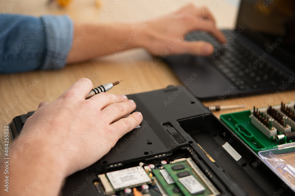 engineer fixing broken computer at work engineer fixing broken computer at work