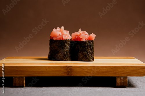 Tuna fish freshly prepared. Japanese food, pieces of tuna, in a wooden background. Fish slices. Front view with Copy Space.