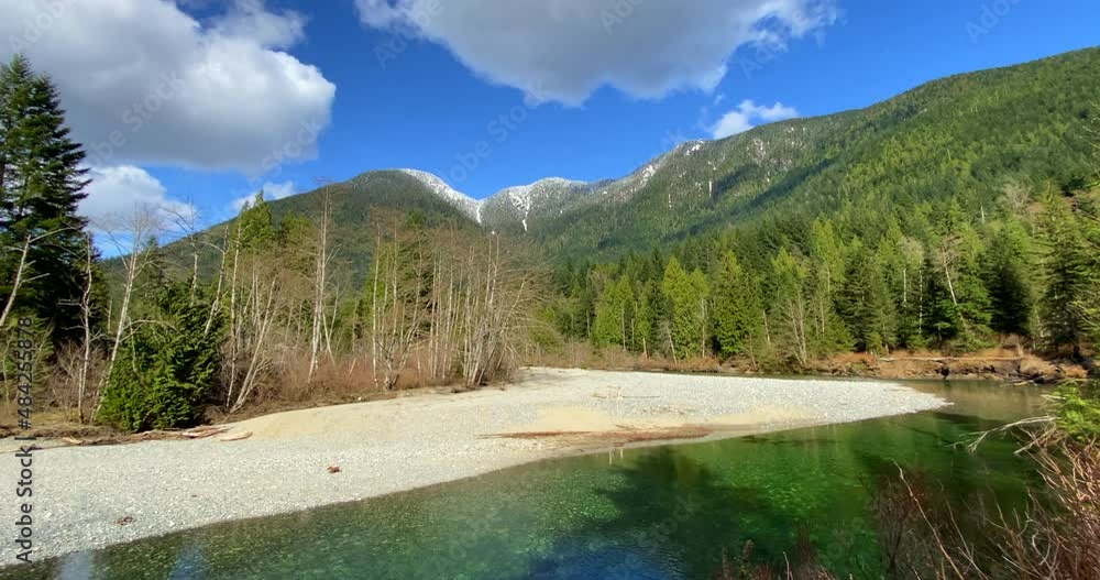 Establishing shot of majestic mountain creek with rocky background in Vancouver, Canada, North America. Day time on September 2021. Still camera view. ProRes 422 HQ. Establishing shot of majestic mountain creek with rocky background in Vancouver, Canada, North America. Day time on September 2021. Still camera view. ProRes 422 HQ.